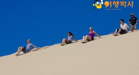 Port Stephens Ulimate Oz trip, Port Stephens Friends slide down sand dunes at Port Stephens on an ultimate Oz trip.